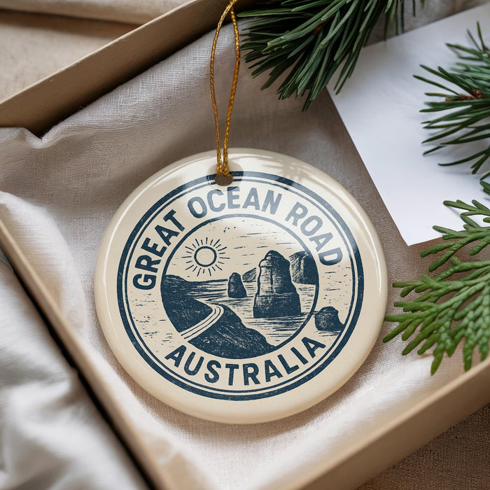 A circular ornament with the text "GREAT OCEAN ROAD AUSTRALIA" printed on it, hanging from a string.
