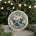 A circular ornament with the text "GREAT OCEAN ROAD AUSTRALIA" printed on it, surrounded by pine branches and lights.