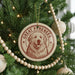 A Christmas tree decorated with ornaments, including a circular ornament with a dog's face and the text "GREAT PYRENEES" printed on it.