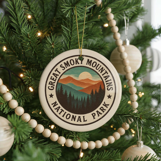 A Christmas tree decorated with ornaments, including a circular ornament with the text "GREAT SMOKY MOUNTAINS NATIONAL PARK" and a wooden bead decoration.