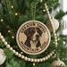 A Christmas tree decorated with ornaments, including a circular ornament with a picture of a mountain dog and the text "GREATER SWISS MOUNTAIN DOG".