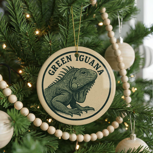 A Christmas tree decorated with ornaments, including a circular ornament featuring a green iguana.