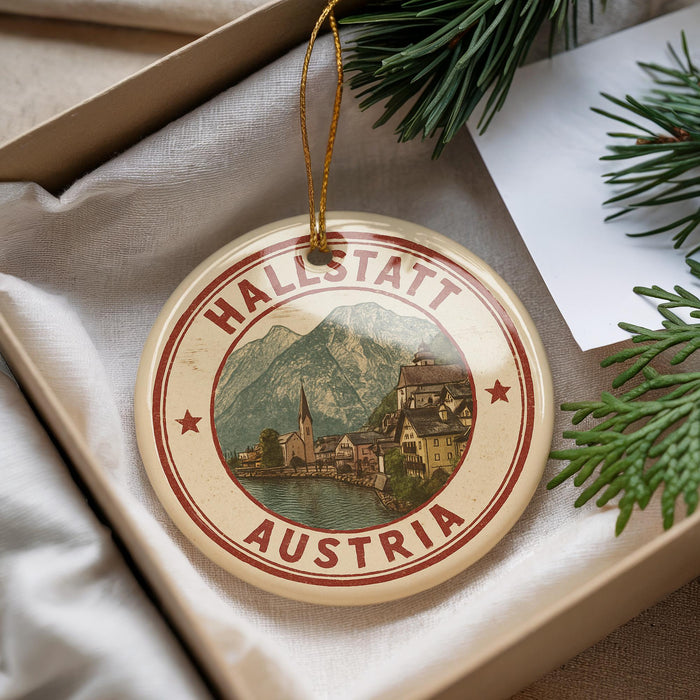 A circular ornament with the text "HALLSTATT AUSTRIA" and an illustration of a town, surrounded by greenery.