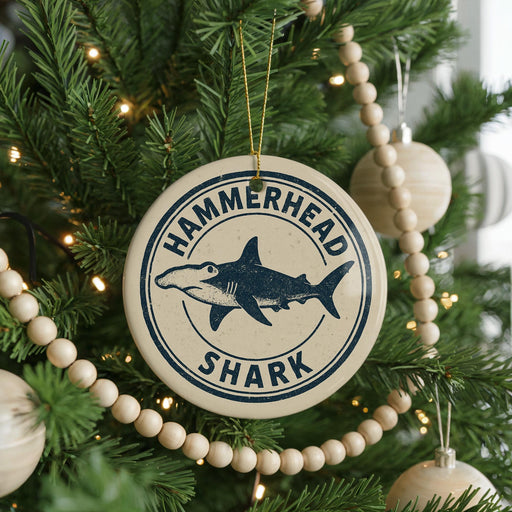 A Christmas tree decorated with ornaments, including a round ornament with a hammerhead shark design and the text "HAMMERTOWN SHARK".