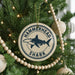 A Christmas tree decorated with ornaments, including a round ornament with a hammerhead shark design and the text "HAMMERTOWN SHARK".