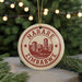 A circular ornament with the text "HARARE ZIMBABWE" printed on it, surrounded by a graphic of a city skyline.