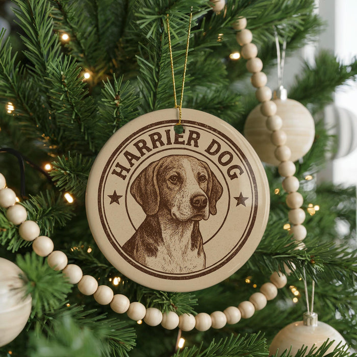 A Christmas tree decorated with ornaments, including a circular ornament with a picture of a dog and the text "Harrier Dog" on it.