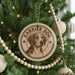 A Christmas tree decorated with ornaments, including a circular ornament with a picture of a dog and the text "Harrier Dog" on it.
