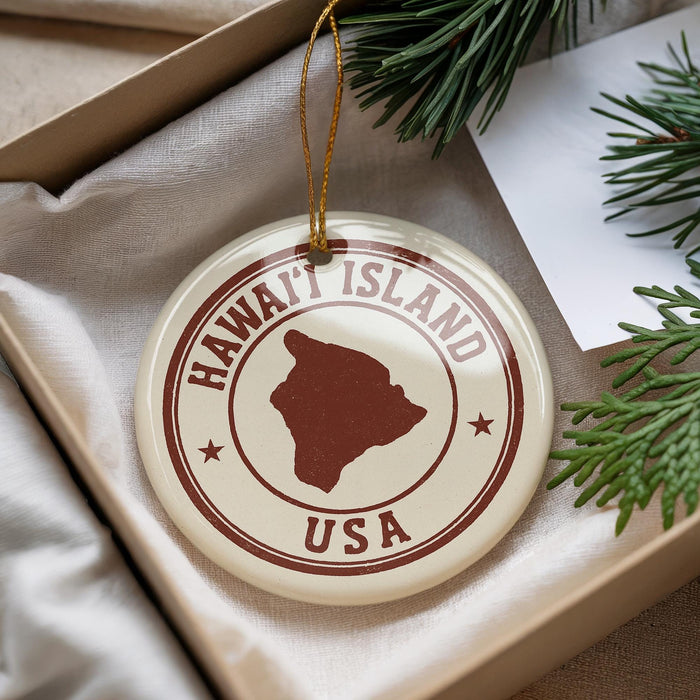 A circular ornament with the text "HAWAII'ISLAND USA" printed on it, surrounded by pine branches.