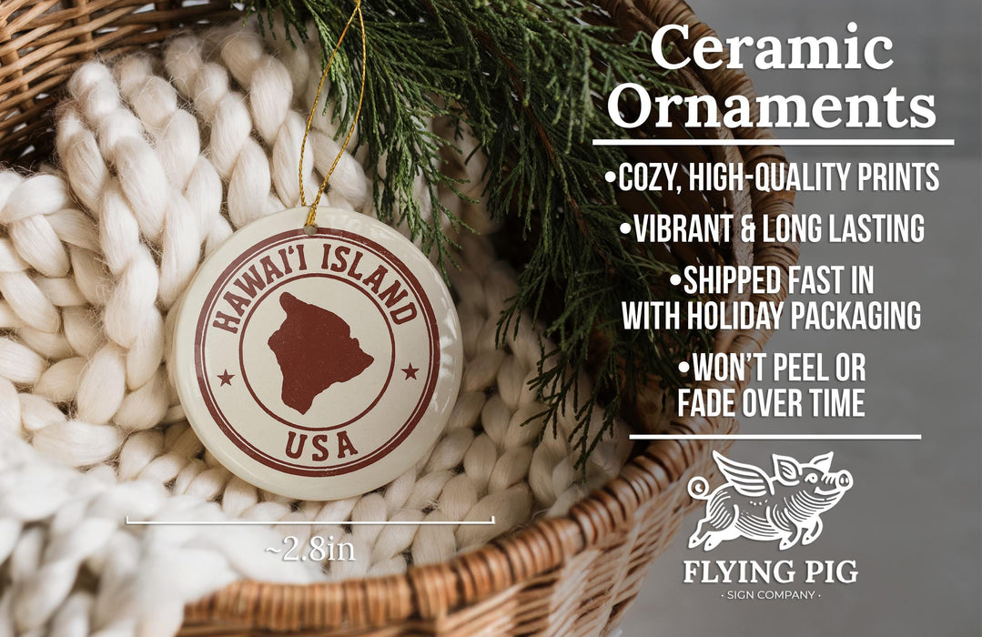 a ceramic ornament hanging from a wicker basket, with a pine branch and greenery in the background. The ornament has a circular design with the text "HAWAII'I ISLAND USA" and a red border. The image also includes text that describes the ornament as "Ceramic Ornaments" and lists features such as "Cozy, high-quality prints", "Vibrant & long lasting", "Shipped fast in", "with holiday packaging", "won't peel or fade over time&q