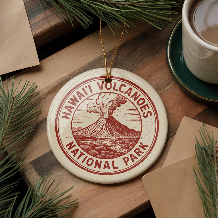 A circular ornament with the text "HAWAII'I VOLCANOES NATIONAL PARK" printed on it, surrounded by pine branches and a cup of coffee on a wooden surface.