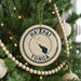 A Christmas tree decorated with ornaments, including a circular ornament with the text "HA'APAI TONGA" and a silhouette of Tonga.