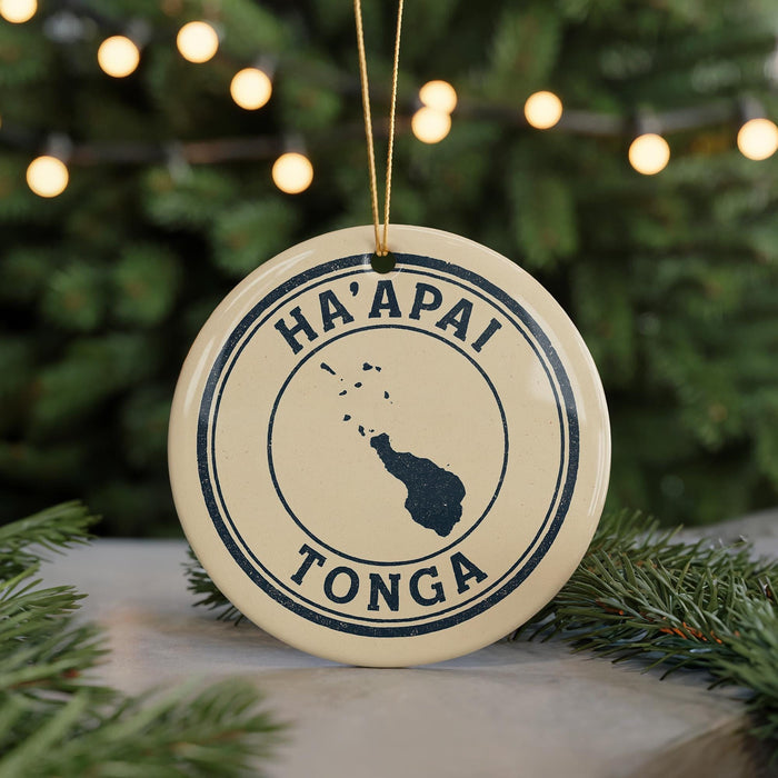 A circular ornament with the text "HA'APAI TONGA" and a map of Tonga, surrounded by Christmas lights and pine branches.