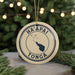 A circular ornament with the text "HA'APAI TONGA" and a map of Tonga, surrounded by Christmas lights and pine branches.