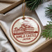 A round ornament with a red and white design depicting the Himeji Castle in Japan, hanging from a string.