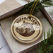 A circular ornament with a hippopotamus image and the text "HIPPOPOTAMUS" is displayed in a box, surrounded by pine branches.