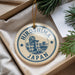 A decorative ornament with the text "HIRO SHIMA JAPAN" printed on it, hanging from a string.