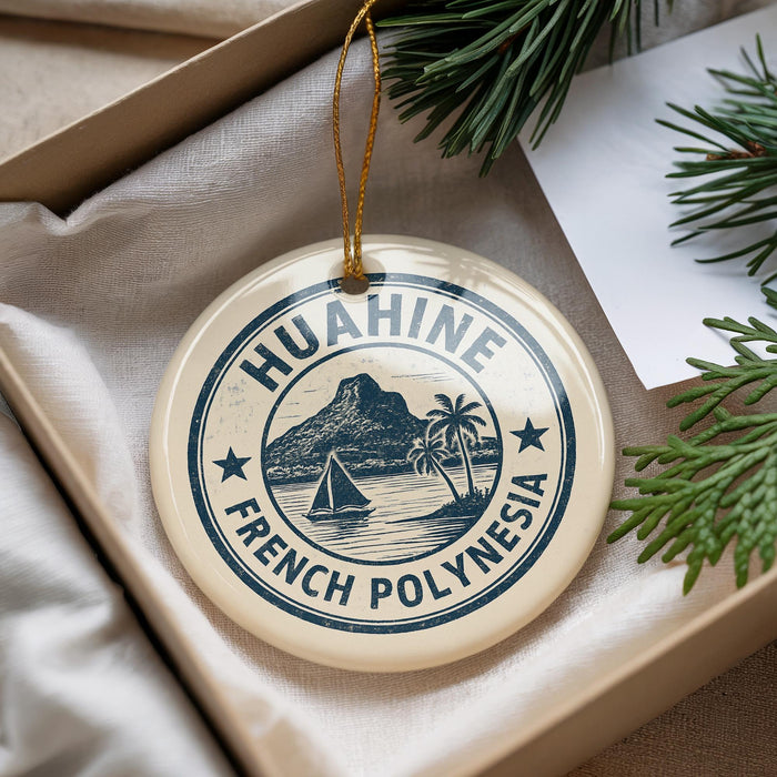 A round ornament with the text "HUAHINE FRENCH POLYNESIA" printed on it, hanging from a string.