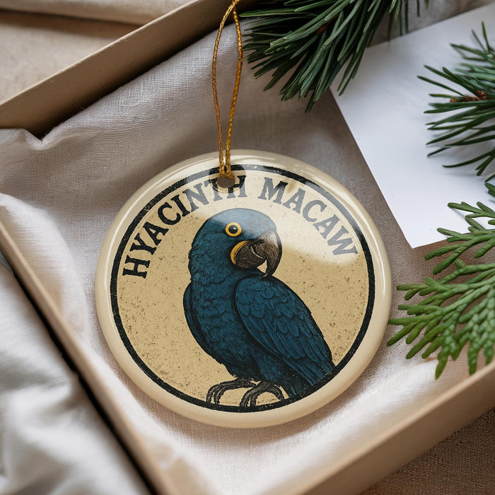 A round ornament featuring a blue parrot, with the text "HVACINTH MACAW" written around the edge.
