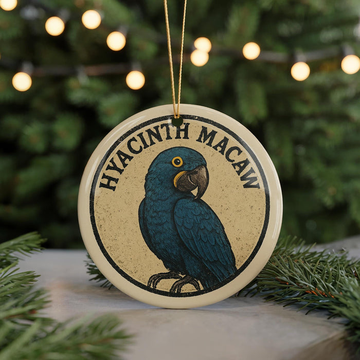A round ornament featuring a blue parrot, with the text "HYACINTH MACAW" written around the bird's image.