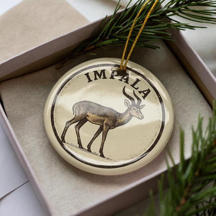A circular ornament with the word "IMPA" on it, featuring an illustration of a deer or antelope.