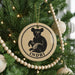 A Christmas tree decorated with ornaments, including a circular ornament featuring a bear and the word "INDRI".