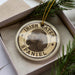 A circular ornament featuring an illustration of an Irish Water Spaniel dog, with the text "Irish Water Spaniel" printed on it.
