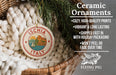Ceramic ornaments, specifically a round ornament with the word "Ichia" and a sailboat, are displayed in a woven basket.