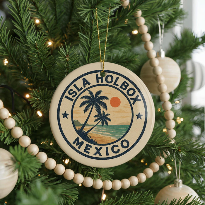 A circular ornament on a Christmas tree, featuring a palm tree and the text "ISLA HOLBOX MEXICO" in a circular design.