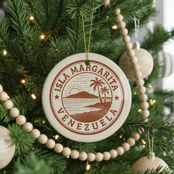 A round ornament on a Christmas tree, featuring the text "ISLA MARGARITA VENEZUELA" and a palm tree design.