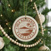 A round ornament on a Christmas tree, featuring the text "ISLA MARGARITA VENEZUELA" and a palm tree design.