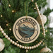 A Christmas tree decorated with a circular ornament that says "Isla Navarino Chile".
