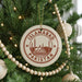 A circular ornament on a Christmas tree, featuring the text "ISLAMABAD PAKISTAN" and an illustration of the Mughal Mosque in Lahore, Pakistan.