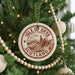 A Christmas tree decorated with ornaments, including a circular ornament with the text "ISLE OF SKYE SCOTLAND" and a mountain landscape.