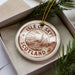 A circular ornament with the text "ISLE OF SKYE SCOTLAND" printed on it, surrounded by pine branches.