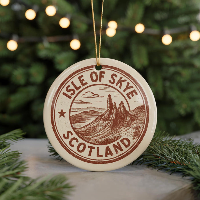 A circular ornament with the text "ISLE OF SKYE SCOTLAND" printed on it, surrounded by pine branches and twinkling lights.