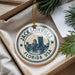 A circular ornament with the text "JACKSONVILLE FLORIDA USA" printed on it, hanging from a string.