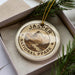 A circular ornament with the text "JASPER NATIONAL PARK CANADA" printed on it, surrounded by pine branches.