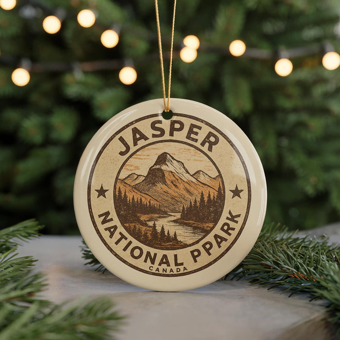 A ceramic ornament with the text "JASPER NATIONAL PARK CANADA" and an illustration of a mountain landscape.