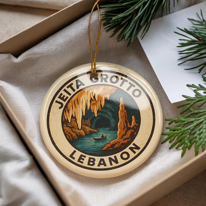 A circular ornament with the text "JEITA GROTTO LEBANON" printed on it, hanging from a string.
