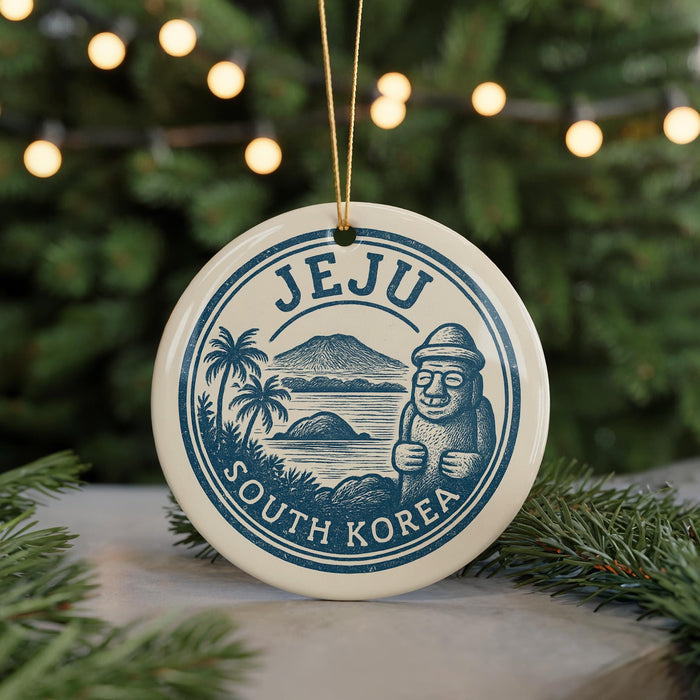 A decorative ornament featuring the text "Jeju South Korea" and an illustration of a stone statue, surrounded by a tropical landscape with palm trees and mountains.