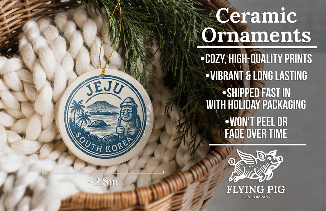 Ceramic ornaments, featuring a round ornament with a blue and white design and text, hanging from a wicker basket with greenery.