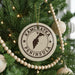 A Christmas tree decorated with ornaments, including a circular ornament with the text "KAMCHATKA PENINSULA" printed on it.