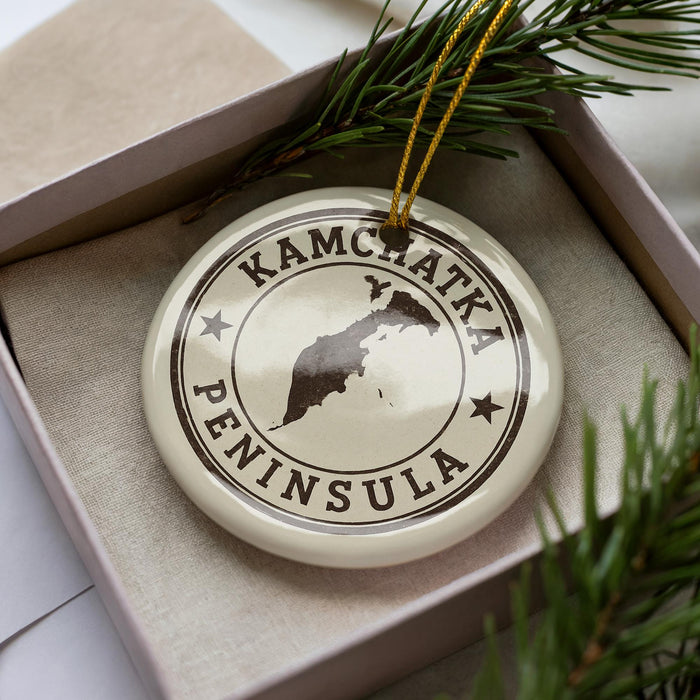A decorative ornament in a box, featuring a map of Kamchatka Peninsula and the text "KAMCHATKA PENINSULA".