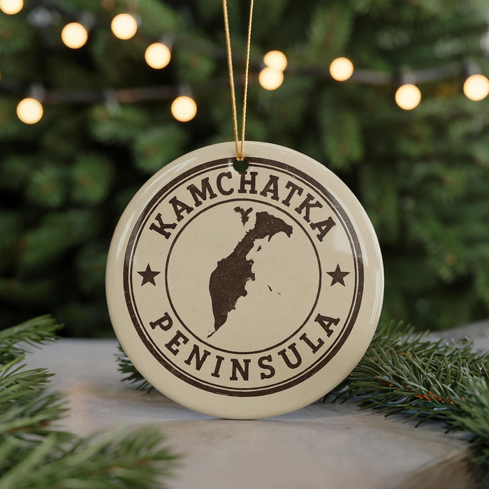 A circular ornament with the text "KAMCHATKA PENINSULA" printed on it, along with a map of the peninsula.