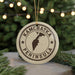 A circular ornament with the text "KAMCHATKA PENINSULA" printed on it, along with a map of the peninsula.