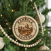 A Christmas tree decorated with ornaments, including a circular ornament with the text "Kampala Uganda" and an illustration of Kampala, Uganda.