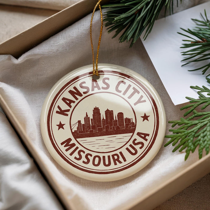 A decorative ornament with the text "KANSAS CITY MISSOURI USA" printed on it, hanging from a string.