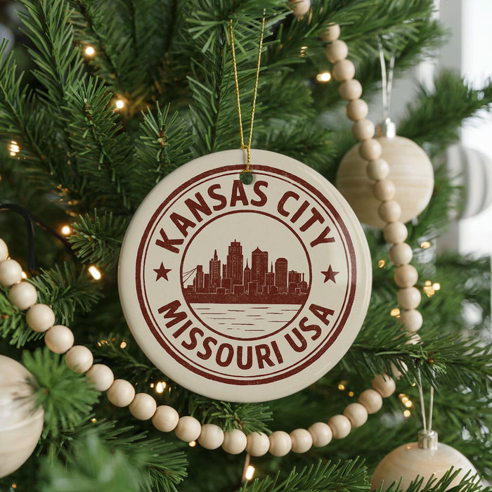 A Christmas tree decorated with ornaments, including a circular ornament with the text "KANSAS CITY MISSOURI USA" and a city skyline silhouette.