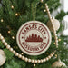 A Christmas tree decorated with ornaments, including a circular ornament with the text "KANSAS CITY MISSOURI USA" and a city skyline silhouette.